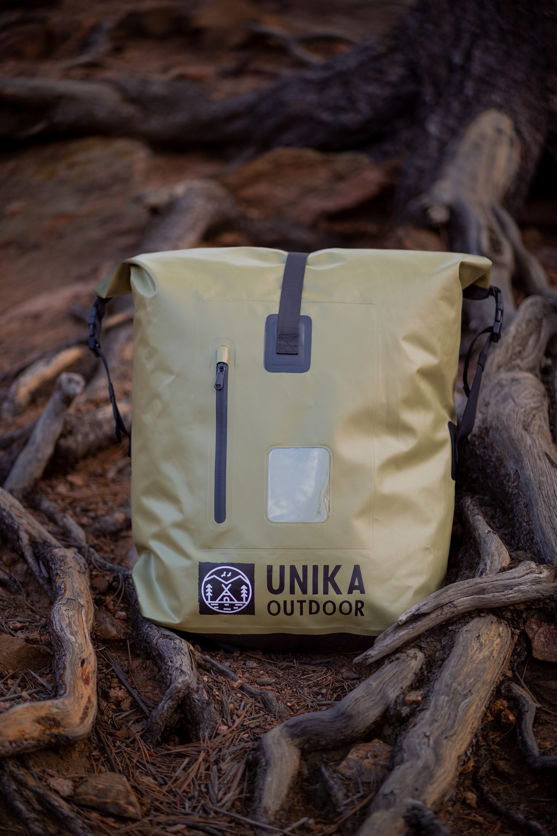 UNIKA green backpack product shot in nature